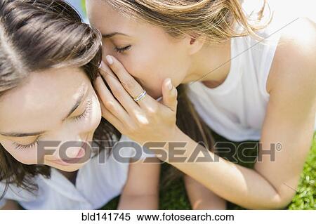 Hispanic women whispering secrets View Large Photo Image Stock Photography - Hispanic women whispering secrets. Fotosearch
