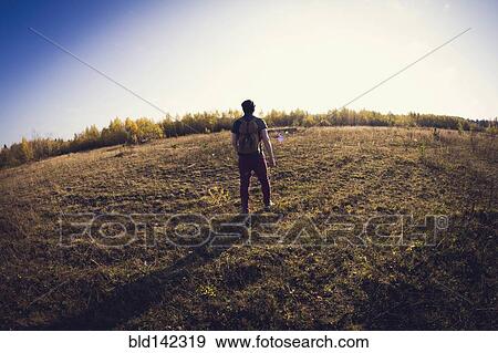 Stock Photo - Man standing in field. Fotosearch