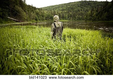 Mari man in wading boots standing in tall marsh grass View Large Photo Image Stock Image - Mari man in wading boots standing in tall marsh grass. Fotosearch