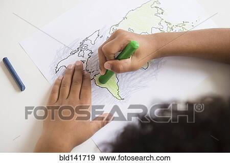 Mixed race boy coloring in world map View Large Photo Image Stock Photo - Mixed race boy coloring in world map. Fotosearch