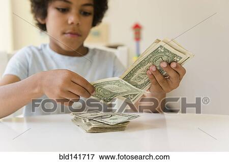 Stock Photo - Mixed race boy counting money. Fotosearch