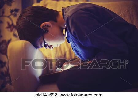 Mixed race boy using digital tablet on sofa View Large Photo Image Stock Image - Mixed race boy using digital tablet on sofa. Fotosearch