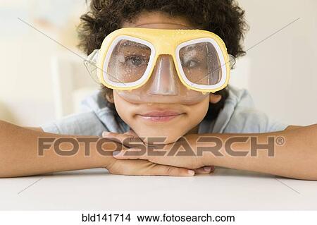 Picture - Mixed race boy wearing wet snorkel mask. Fotosearch