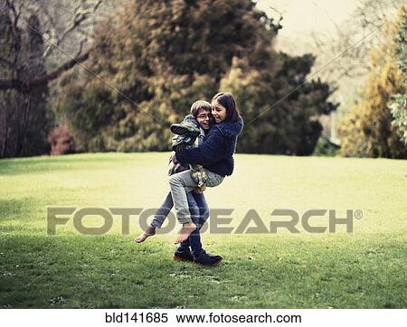 Mixed race brother and sister playing in field View Large Photo Image Stock Photography - Mixed race brother and sister playing in field. Fotosearch