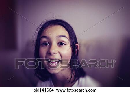 Picture - Mixed race girl laughing. Fotosearch