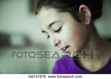 Stock Photograph - Mixed race girl looking down. Fotosearch