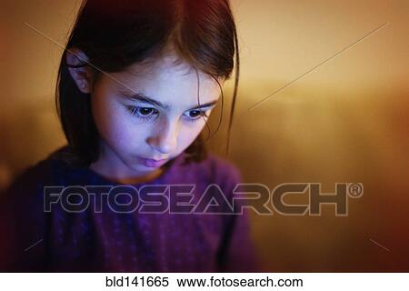 Stock Photography - Mixed race girl looking down. Fotosearch