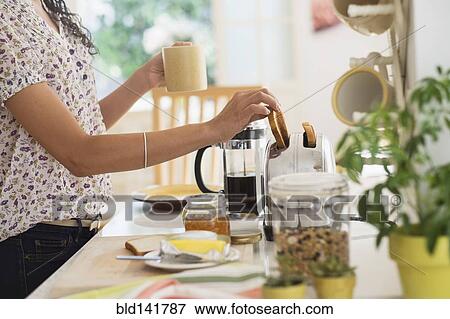 Mixed race woman preparing breakfast in kitchen View Large Photo Image Stock Photo - Mixed race woman preparing breakfast in kitchen. Fotosearch