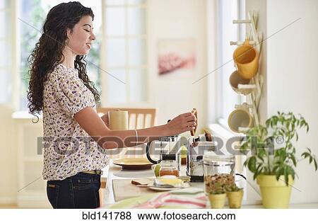 Mixed race woman preparing breakfast in kitchen View Large Photo Image Stock Photo - Mixed race woman preparing breakfast in kitchen. Fotosearch