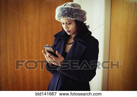 Mixed race woman using cell phone View Large Photo Image Stock Photo - Mixed race woman using cell phone. Fotosearch