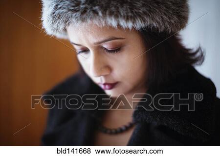 Mixed race woman wearing furry hat and coat View Large Photo Image Stock Photo - Mixed race woman wearing furry hat and coat. Fotosearch