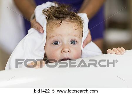 Stock Photography - Mother drying hair of baby son. Fotosearch