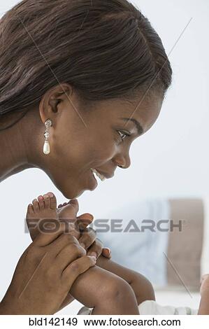 Stock Photo - Mother playing with baby son. Fotosearch