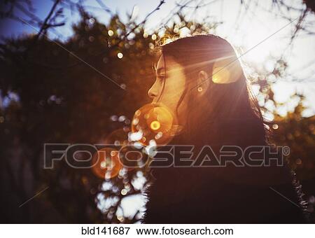 Stock Photo - Profile of mixed race girl outdoors. Fotosearch