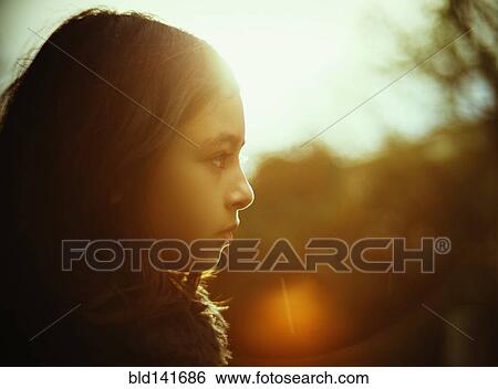 Stock Photograph - Profile of mixed race girl outdoors. Fotosearch