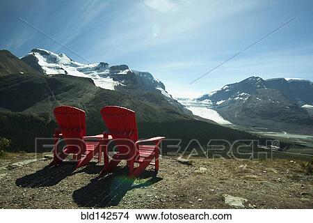 Red lawn chairs overlooking scenic mountain landscape View Large Photo Image Picture - Red lawn chairs overlooking scenic mountain landscape. Fotosearch