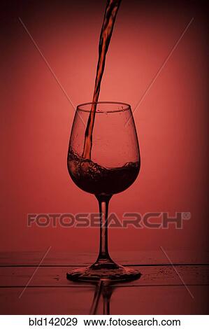 Red wine pouring into wine glass View Large Photo Image Stock Photo - Red wine pouring into wine glass. Fotosearch