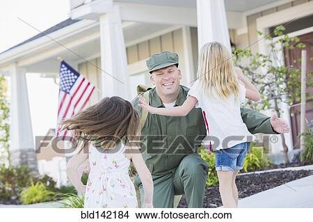 Returning Caucasian soldier hugging daughters View Large Photo Image Picture - Returning Caucasian soldier hugging daughters. Fotosearch