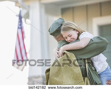 Stock Image - Returning Caucasian soldier hugging daughter. Fotosearch