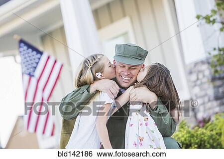 Returning Caucasian soldier hugging daughters View Large Photo Image Stock Photograph - Returning Caucasian soldier hugging daughters. Fotosearch