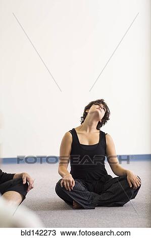 Stock Image - Student stretching in acting class. Fotosearch