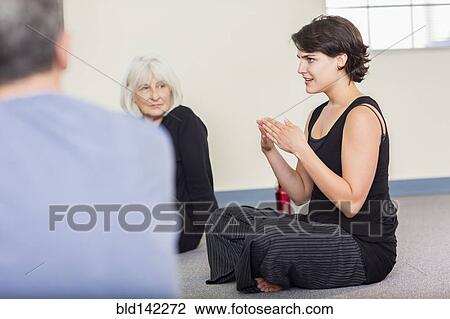 Stock Image - Student talking in acting class. Fotosearch