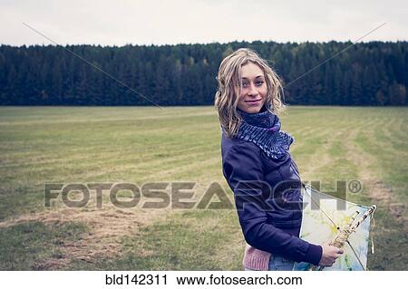 Woman holding kite in field View Large Photo Image Stock Image - Woman holding kite in field. Fotosearch