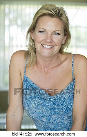Stock Photography - Woman smiling indoors. Fotosearch