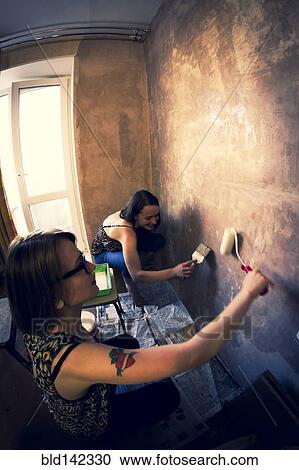 Women painting wall View Large Photo Image Stock Image - Women painting wall. Fotosearch