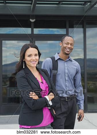 Business people smiling outside office building View Large Photo Image Stock Image - Business people smiling outside office building. Fotosearch