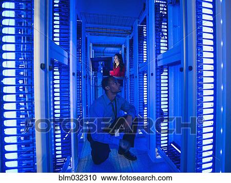 Business people working in server room View Large Photo Image Stock Image - Business people working in server room. Fotosearch