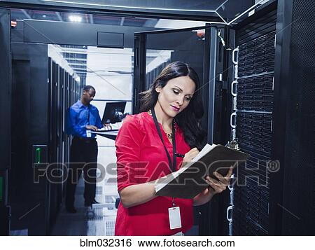 Business people working in server room View Large Photo Image Stock Photograph - Business people working in server room. Fotosearch