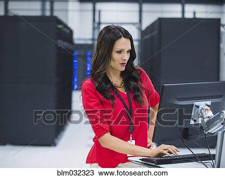 Caucasian businesswoman using computer in server room View Large Photo Image Stock Image - Caucasian businesswoman using computer in server room. Fotosearch