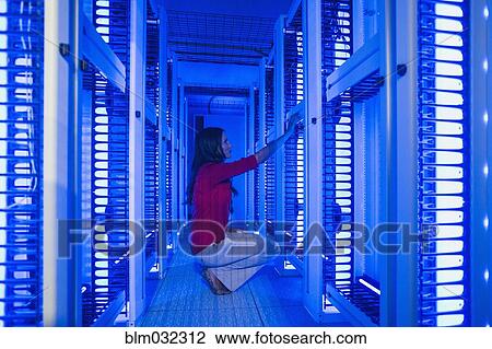 Caucasian businesswoman working in server room View Large Photo Image Stock Image - Caucasian businesswoman working in server room. Fotosearch
