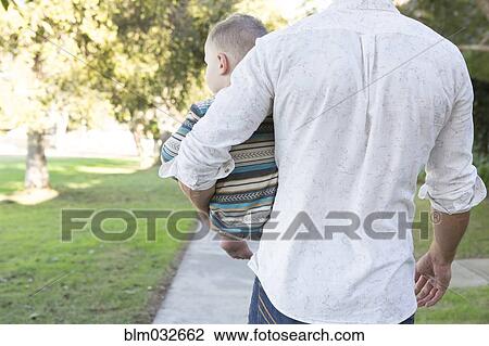 Caucasian father carrying son on sidewalk View Large Photo Image Stock Image - Caucasian father carrying son on sidewalk. Fotosearch