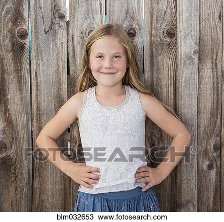 Caucasian girl smiling with hands on hips View Large Photo Image Stock Image - Caucasian girl smiling with hands on hips. Fotosearch