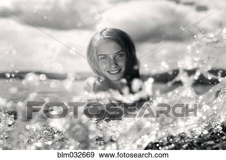 Caucasian girl splashing in lake View Large Photo Image Stock Photo - Caucasian girl splashing in lake. Fotosearch