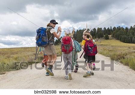 Caucasian hiker leading children on path in remote landscape View Large Photo Image Stock Photo - Caucasian hiker leading children on path in remote landscape. Fotosearch