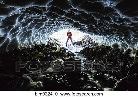 Caucasian hiker viewing stream from entrance of ice cave View Large Photo Image Stock Image - Caucasian hiker viewing stream from entrance of ice cave. Fotosearch
