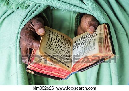 Close up of hands of priest holding Bible View Large Photo Image Stock Photograph - Close up of hands of priest holding Bible. Fotosearch
