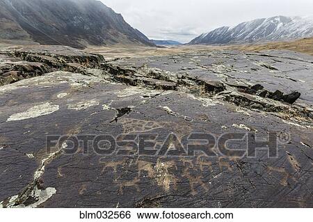 Stock Photograph - Close up of petroglyphs on rock formations, Altai Tavn Bogd National Park, Bayan Ulgii, Mongolia. Fotosearch
