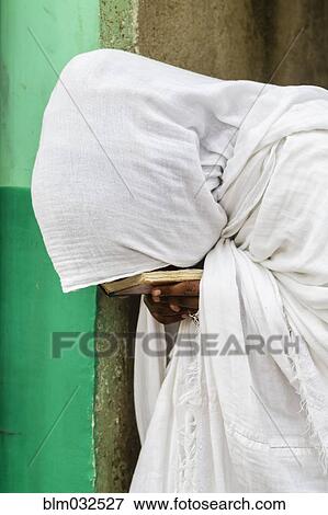 Close up of pilgrim praying in white robes View Large Photo Image Stock Photo - Close up of pilgrim praying in white robes. Fotosearch