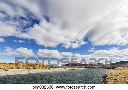 Clouds over river in remote landscape View Large Photo Image Stock Photo - Clouds over river in remote landscape. Fotosearch