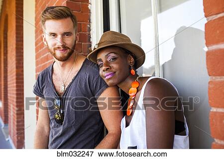 Stock Photo - Couple sitting together outdoors. Fotosearch