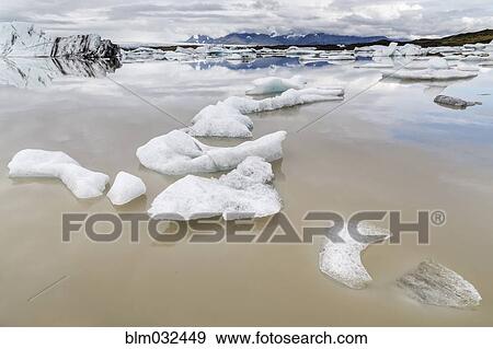 Glaciers floating in still arctic water View Large Photo Image Stock Photo - Glaciers floating in still arctic water. Fotosearch