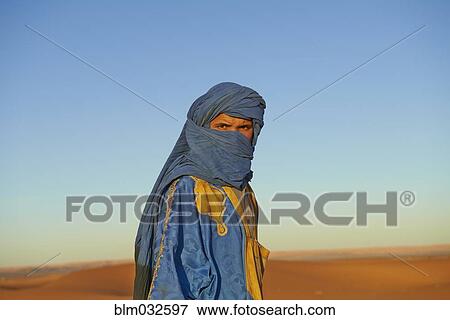 Guide wearing face protection in desert landscape View Large Photo Image Stock Photo - Guide wearing face protection in desert landscape. Fotosearch
