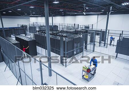 Stock Photography - High angle view of Black businessman working in server room. Fotosearch