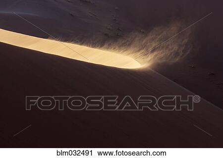 High angle view of sand blowing from sand dune in desert View Large Photo Image Stock Image - High angle view of sand blowing from sand dune in desert. Fotosearch