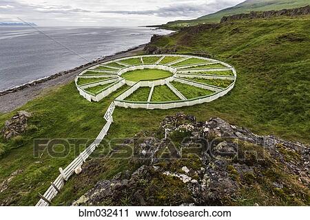 Stock Image - High angle view of sheep pens on rural cliff. Fotosearch
