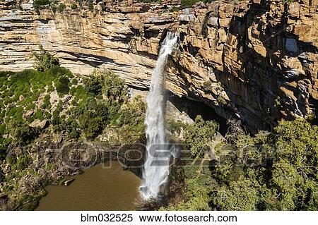 High angle view of waterfall flowing over rocky cliff View Large Photo Image Stock Photography - High angle view of waterfall flowing over rocky cliff. Fotosearch